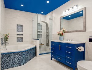 A modern bathroom accented with electric blue features.