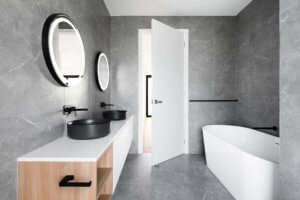 A minimalistic modern bathroom filled with stone and wood.