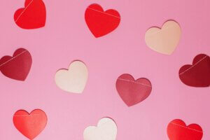 Red, Pink, purple, and white hearts on a pink background