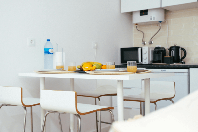 Bright kitchen breakfast table with fruit and drinks